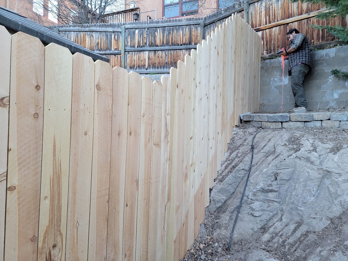 Cedar fence on rocky NM terrain