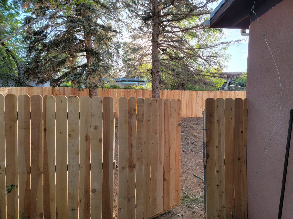 Dog-ear cedar fence with gate